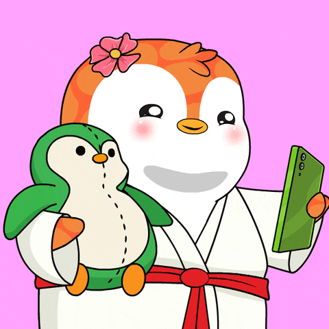 a penguin holding a stuffed penguin and a cell phone