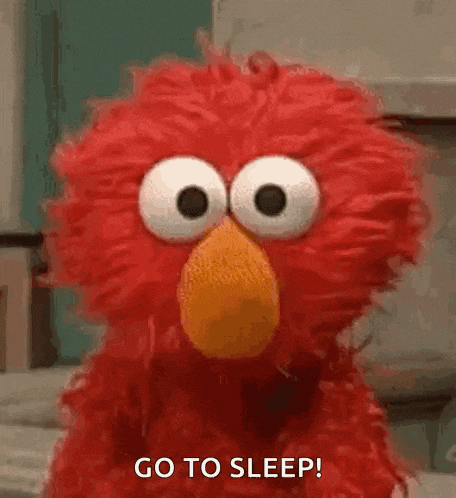 elmo from sesame street is making a funny face and saying go to sleep .