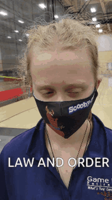 a person wearing a scooby doo face mask with the words law and order below them
