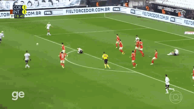 a group of soccer players are on a field with the word ge on the bottom right