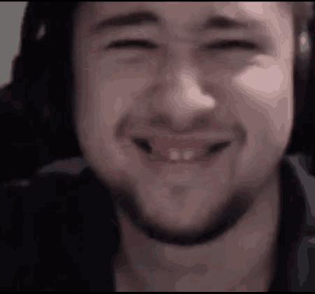 a close up of a man 's face with a beard and headphones on .