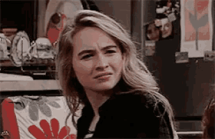 a woman with blonde hair is making a funny face