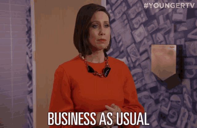 a woman says business as usual while standing in a bathroom