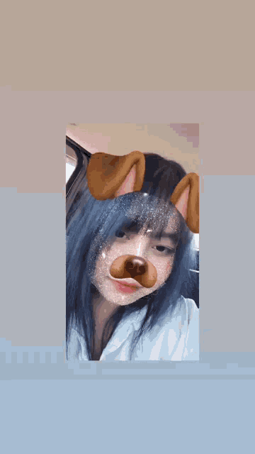 a girl with blue hair is wearing a dog face mask