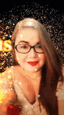 a woman wearing glasses and red lipstick stands in front of a sign that says ' christmas '