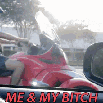 a picture of a person riding a red motorcycle with the words me & my bitch