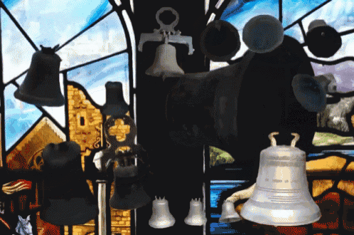 a stained glass window with a bunch of bells hanging from it