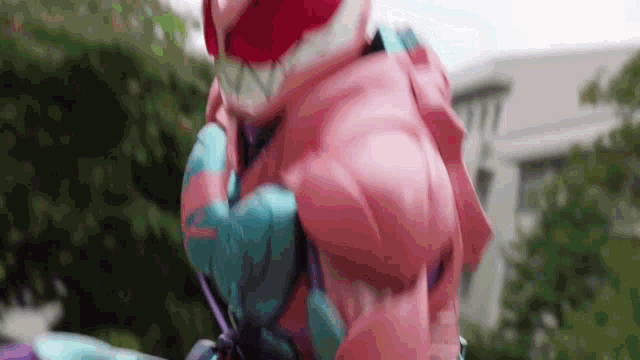 a close up of a person in a pink and blue superhero costume .