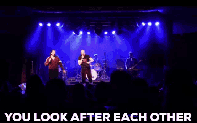 a group of people on a stage with the words " you look after each other " above them