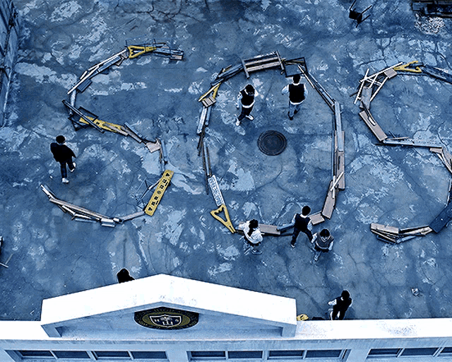 a group of people are standing in a circle on a concrete surface that says sgc on it