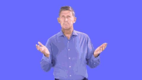 a man in a blue shirt is shrugging his shoulders and making a funny face