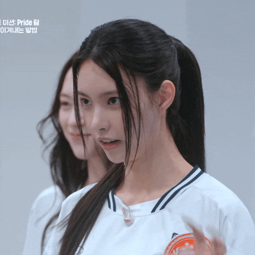 a girl in a white shirt with the word pride on the bottom
