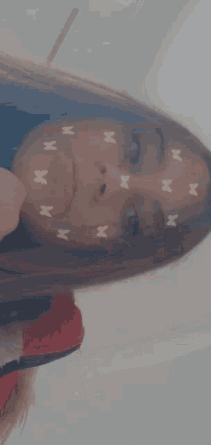a close up of a girl 's face with butterfly stickers on it