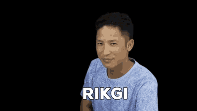 a man in a blue shirt with the name rikgi on it