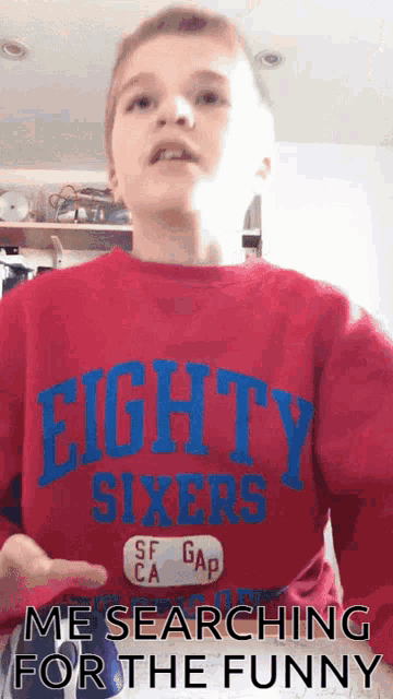 a boy wearing an eighty sixers shirt is searching for the funny