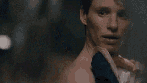 a close up of a person holding a tissue over their arm .