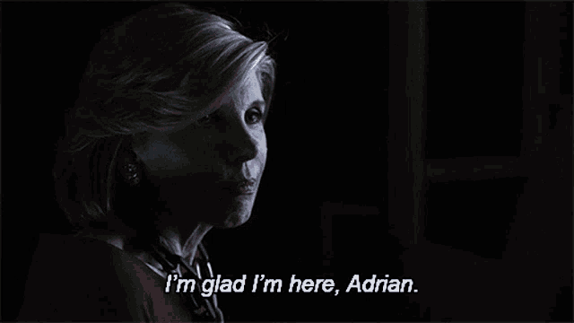 a woman says i 'm glad i 'm here adrian in a dark room