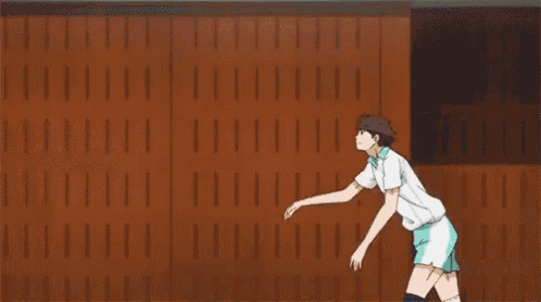 a volleyball player is jumping in the air in front of a banner that says `` i love you '' .