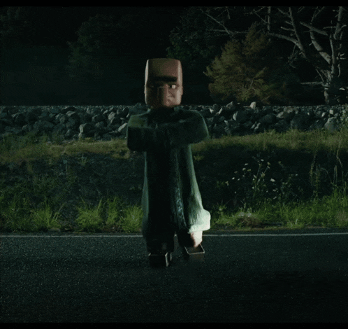 a statue of a minecraft character standing on the side of a road