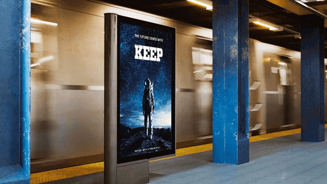 a movie poster for keep is displayed in a train station