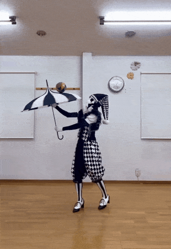 a clown is holding an umbrella in a room with a clock on the wall behind him