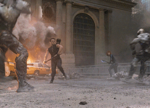 a man holding a bow and arrow in front of a building