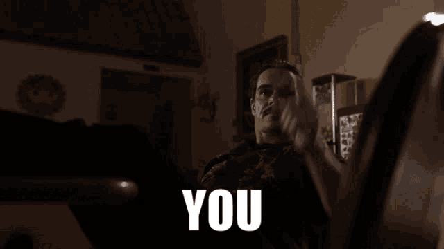 a man giving a thumbs up with the word you in the foreground