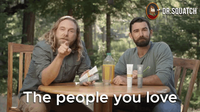 two men sitting at a table with the words " the people you love "
