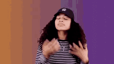 a woman wearing a black hat and a striped shirt