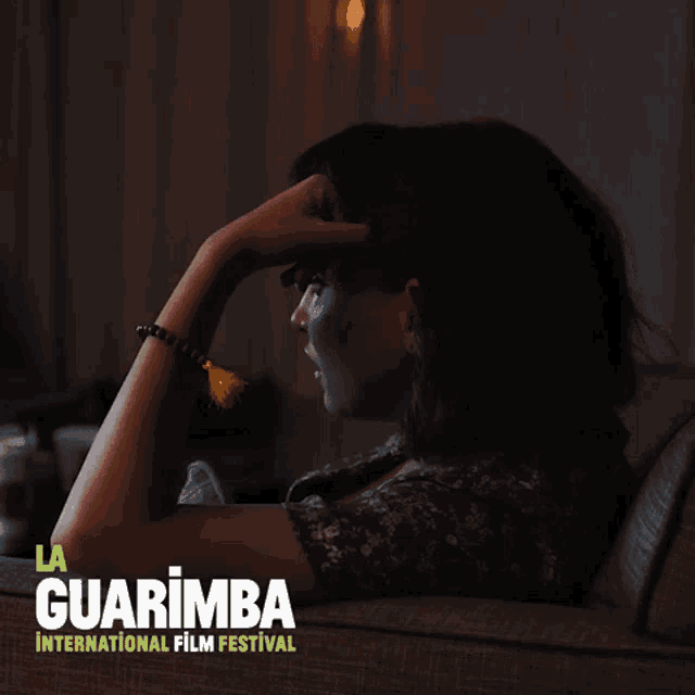 a poster for the la guarimba international film festival shows a woman sitting on a couch