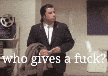 a man in a suit is standing in front of a sign that says who gives a fuck ?