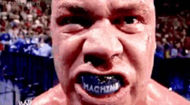 a close up of a man with a mouth guard that says machine