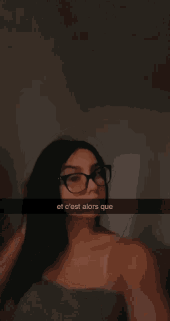 a woman wearing glasses is taking a selfie with the caption et c'est alors que