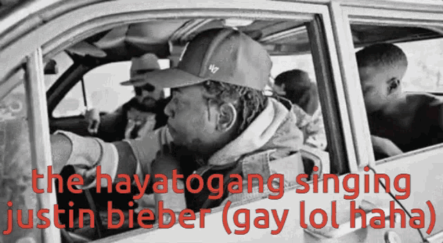 a black and white photo of a man in a car with the words " the hayatogang singing justin bieber "