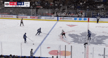 a toronto maple leafs hockey game is underway with a score of 5 to 5