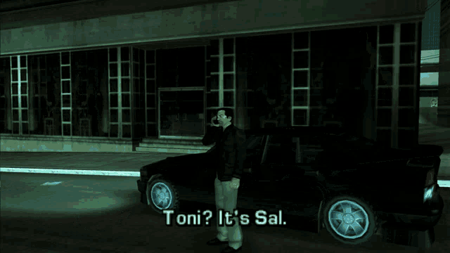 a man talking on a cell phone in front of a car that says toni