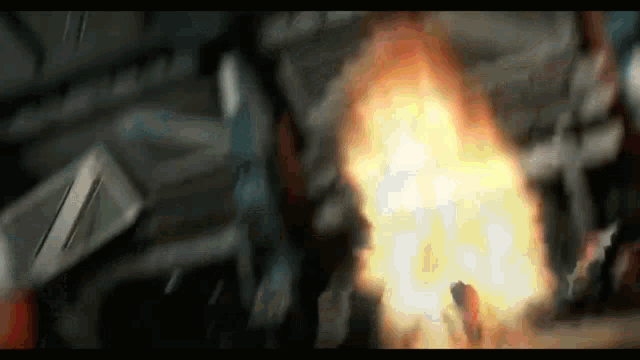 a person is standing in front of a large fireball
