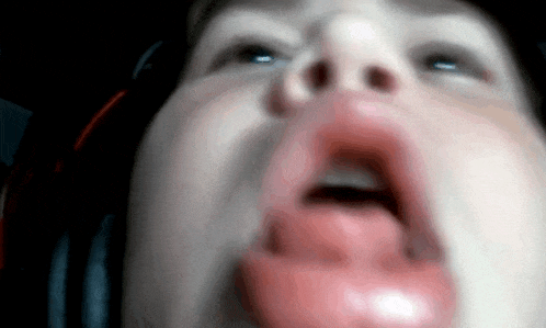 a close up of a person with their mouth open