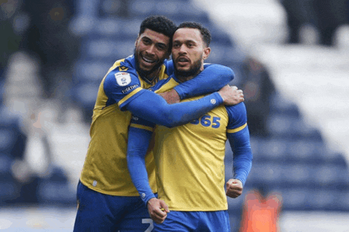 two soccer players one wearing a jersey with the number 365 on it