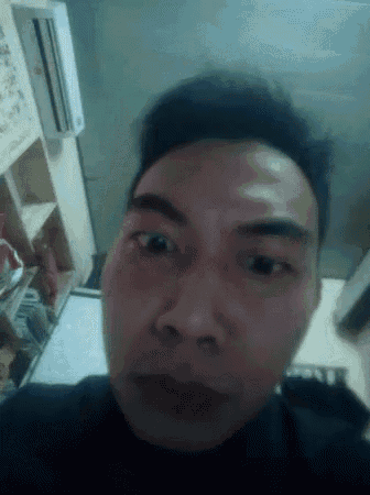 a close up of a man 's face in a room with an air conditioner
