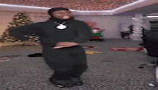 a man in a black suit is dancing in a living room .