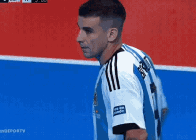 a soccer player wearing a blue and white jersey with the word argentina on the front