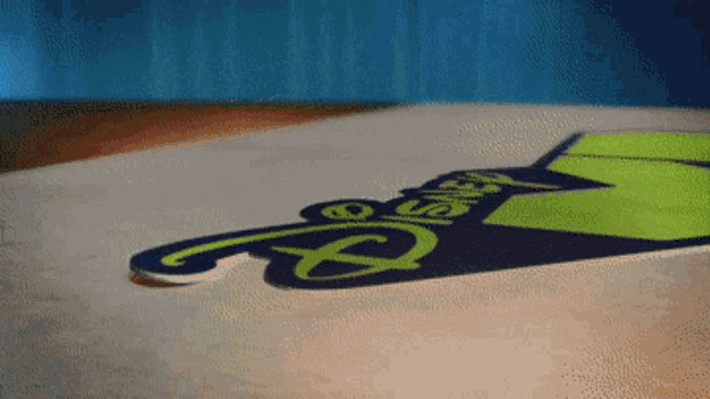 a sign that says disney on it is laying on the ground