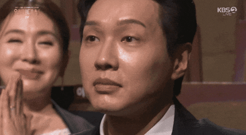 a close up of a man 's face with kbs live written on the bottom right