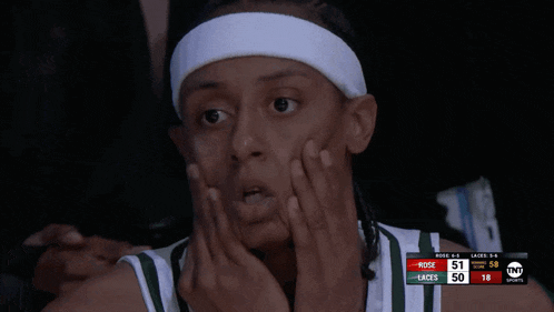 a basketball player wearing a white headband is watching a game between the bucks and the laces