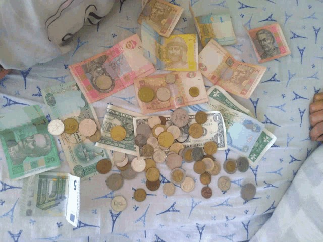 a pile of foreign currency including one dollar bill