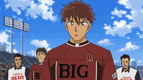 a soccer player wearing a big jersey stands in front of a crowd