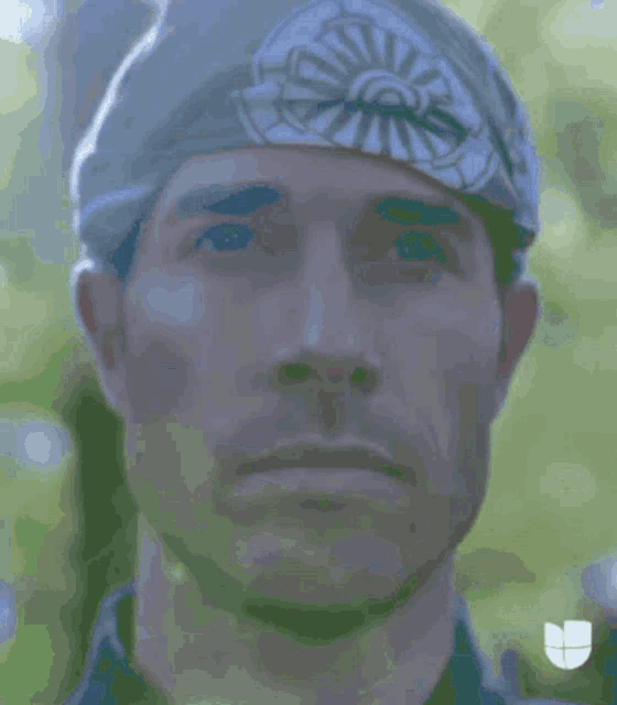 a close up of a man 's face behind a fence .