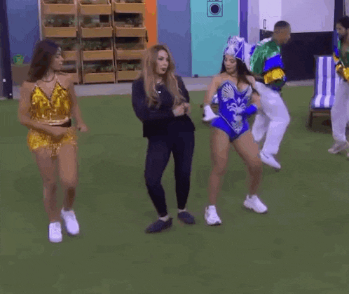 a group of women are dancing together on a field .