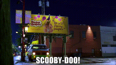 a scooby doo van is driving past a billboard that says i 'm a lil party poop